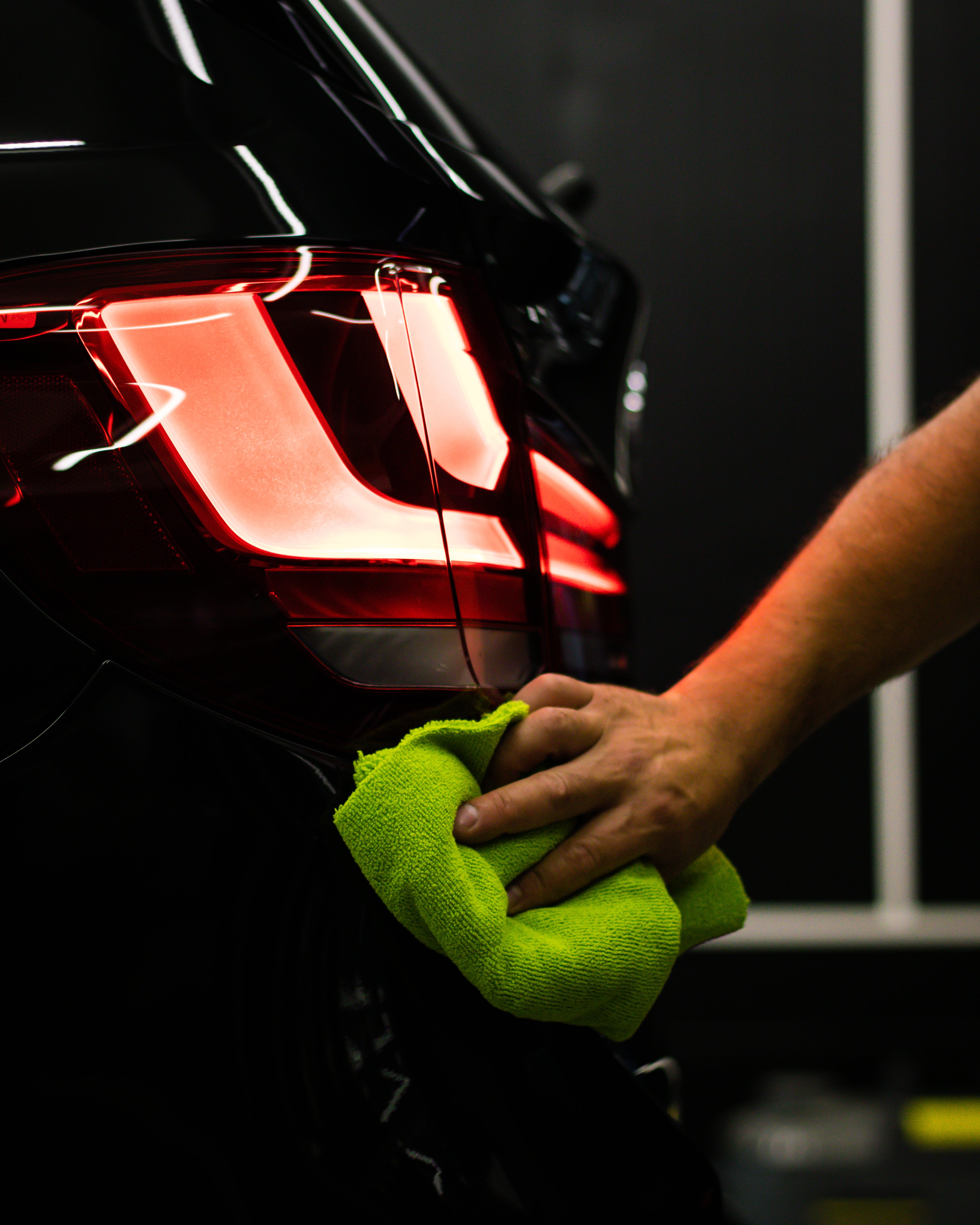 1755892730380-selective-focus-shot-man-cleaning-car-s-back-headlight-with-microfiber-cloth.jpg